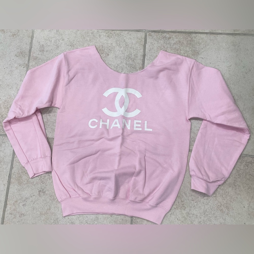 Light pink CC off the shoulder sweatshirt.
